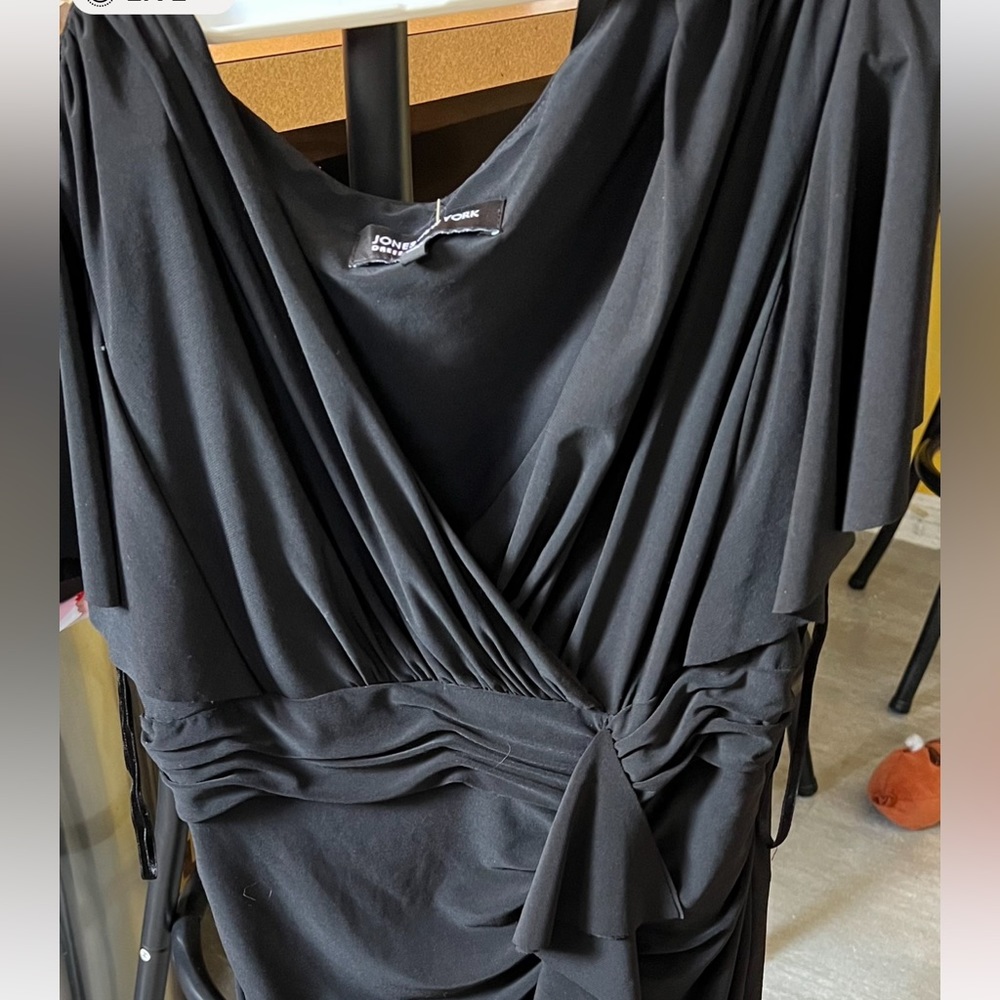 Long black dress with flutter sleeves and gathering with ruffles on waist.